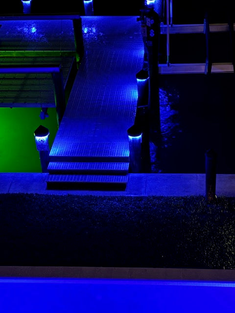 12V black piling cap light with dynamic RGBW LED output lit blue at night
