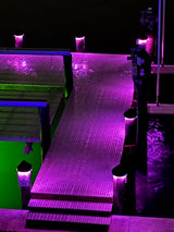 12V black piling cap light with dynamic RGBW LED output lit blue at night
