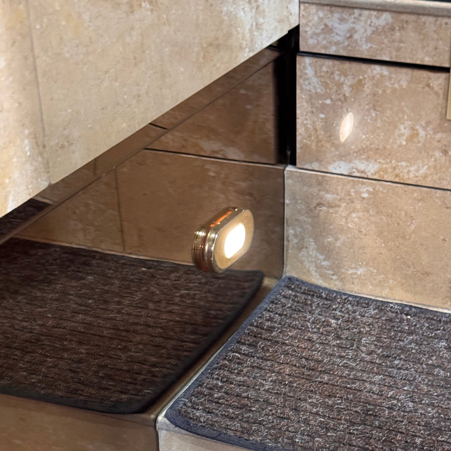 rv bimini step light gold oval courtesy light highlighting its slim profile close up