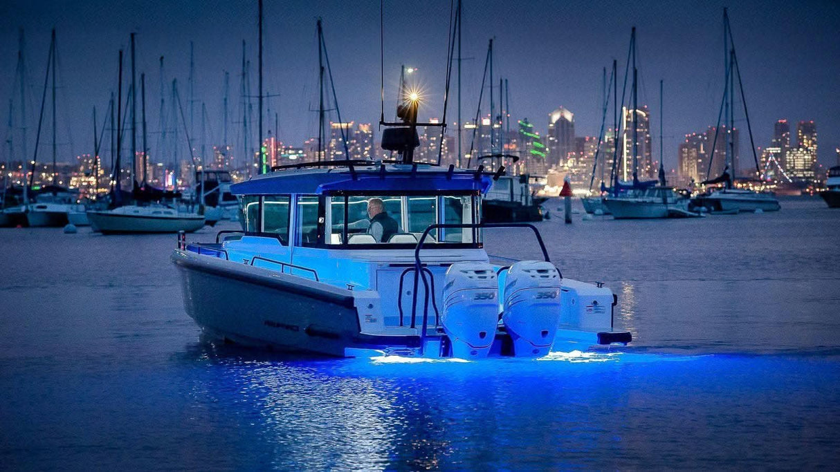 SUPRA THX404 Thru-Hull Underwater LED Light blue on center console at night
