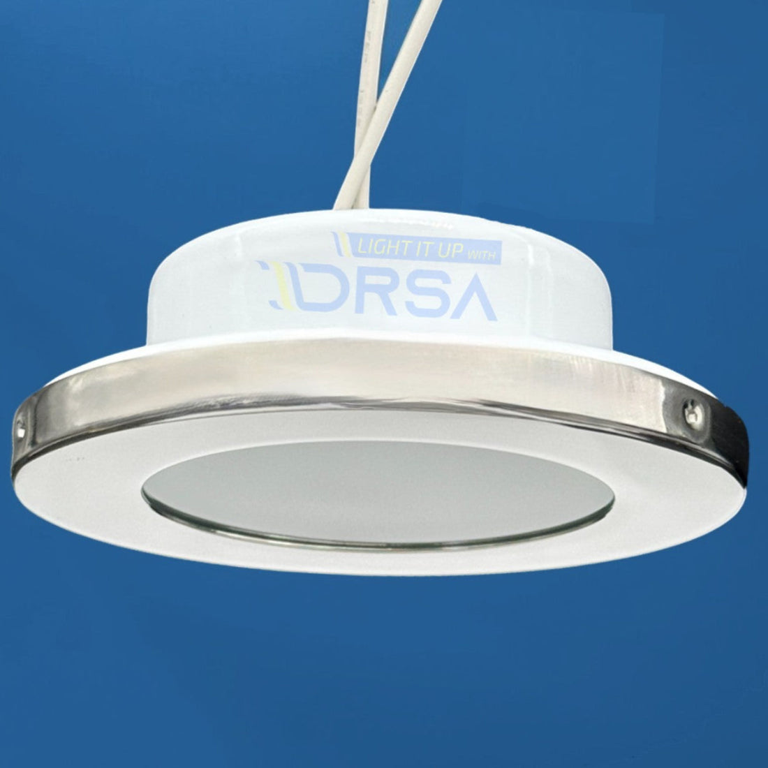 Flush mount Montserrat G4 socket light with polished stainless bezel side view blue background