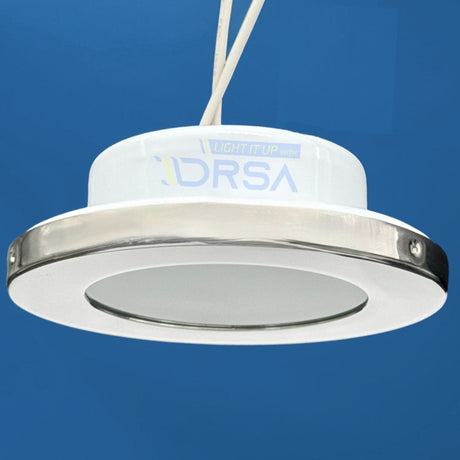 Flush mount Montserrat G4 socket light with polished stainless bezel side view blue background