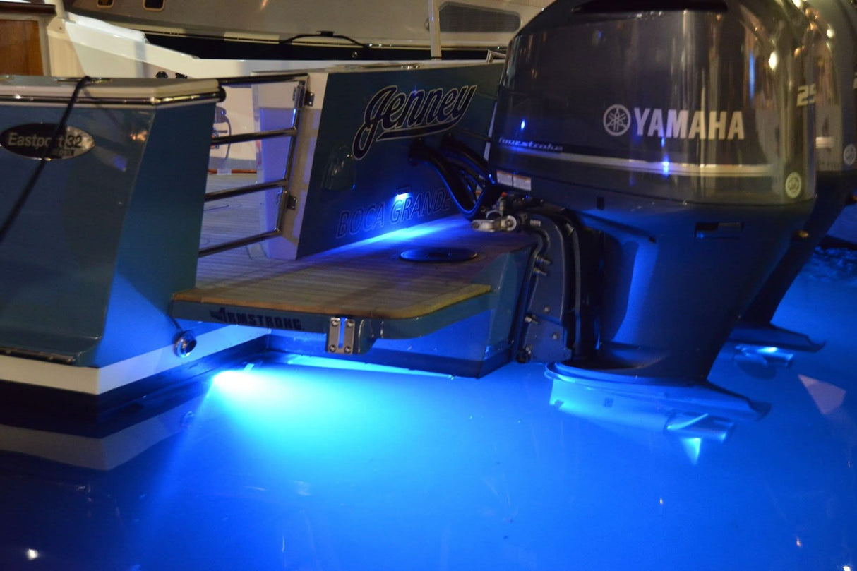SeaBlaze Mini Spectrum underwater light, 870 lumens, RGBW, Poco compatible, compact design installed at night next too outboards