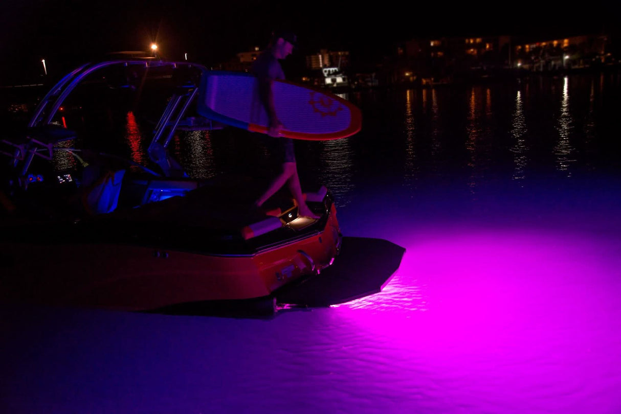 Javelin 600X underwater light, sleek rectangular design, RGBW output installed on wakeboat at night pink led