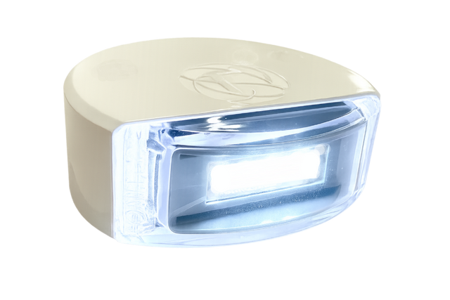 Lumitec Surface Mount Composite Navigation Light Stern White illuminating a boat’s stern at night  101868